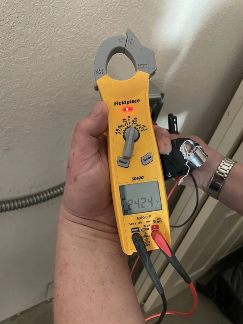 Voltage testing with clamp meter during Electrical Installation Services in Bettendorf